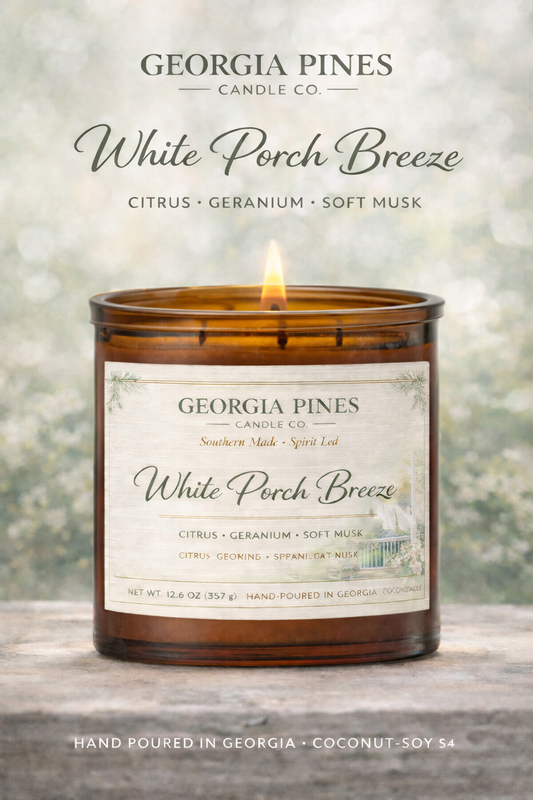 Georgia Pines candle labeled 'White Porch Breeze' on a wooden surface with a blurred background.